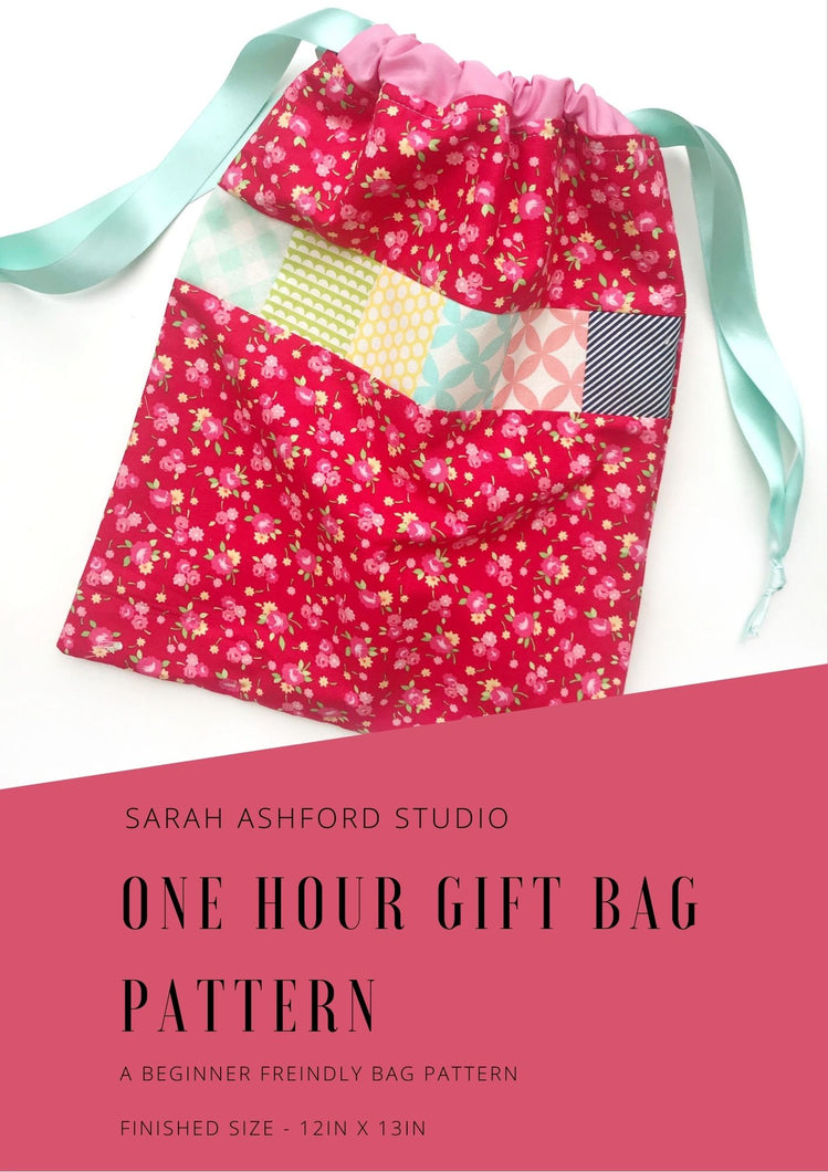 Sewing pattern, gift bag. A red floral fabric drawstring bag has a strip of patchwork  detail across the middle.  It is drawn up with green ribbon, through pink casing. 